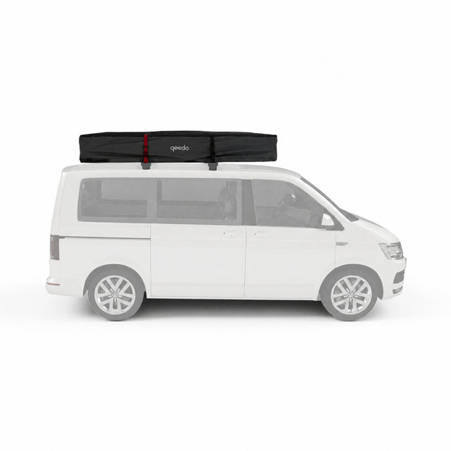 Qeedo Freedom Family Dachzelt - verpackt in schwarzer Transporttasche auf dem Dach eines weißen Vans